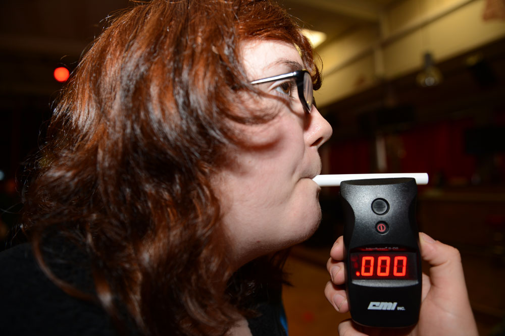 woman taking a breathalyzer test